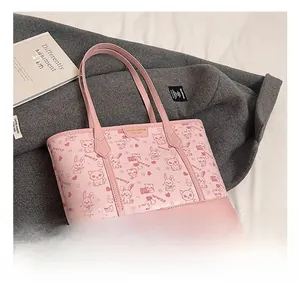 Detail of pink PU tote bag featuring cute cartoon animal prints and metal logo