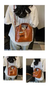 Detailed view of brown vintage PU leather tote bag with sturdy handles and shoulder strap