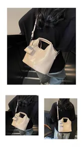 Three-way view of a beige oil leather tote with matching mini pouch and shoulder strap
