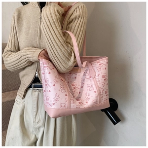 Detail of pink tote bag featuring cute cartoon animals and reinforced bottom stitching