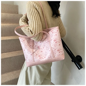 Close-up of pink tote bag featuring cute cartoon animal prints and wmst lettering