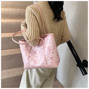 Rear view of a pink cartoon tote bag with animal prints and wide shoulder strap