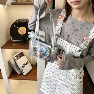 Detail of silver laser mirror ita bag with transparent window and lace bow decoration