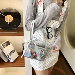 Close-up of holographic silver Ita bag featuring a heart-shaped clear window and lace bow