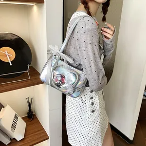 Silver laser ita-bag featuring transparent window with lace trim and ribbon bow detail