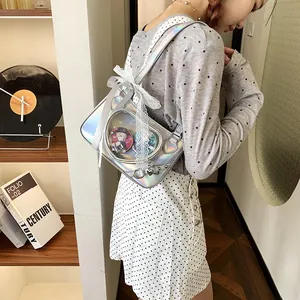 Detail of holographic ita bag with heart window and lace bow featuring anime badges