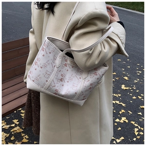 Detailed close-up of large tote bag featuring cute cartoon cat and rabbit animal prints