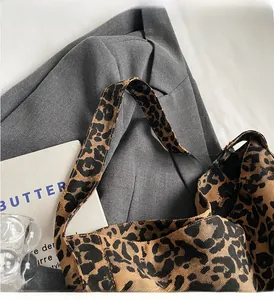 Detail of leopard print tote bag showing the reinforced handle and durable canvas texture