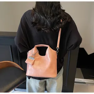 Pink oily leather tote bag with matching chain pouch and removable shoulder strap