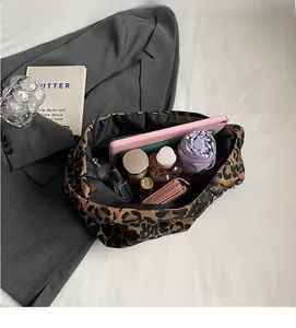 Top view of large leopard print tote bag interior showing various items and storage space