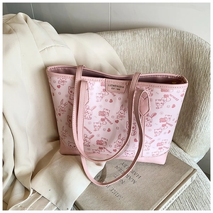 Detailed view of pink tote bag with cute animal prints and durable leather texture