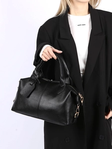 Detail of black lychee grain leather tote bag with gold hardware and round handles