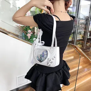 Detailed view of white heart ita bag with transparent window and lace ribbon decoration