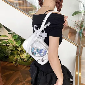 Detail of white glossy leather ita bag with lace bow and triangular clear window