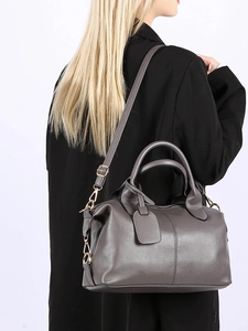 Deep grey litchi grain leather tote bag with round handles shown on a model