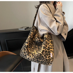 Detail of leopard print tote bag featuring a DOUGU BAG label and spacious canvas structure