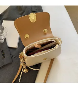 Interior view showing the spacious main compartment and pockets of this chic beige handbag