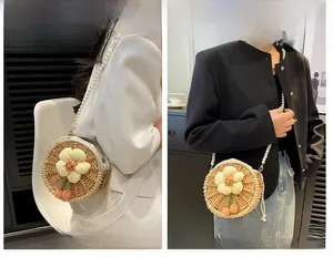 Detail of round straw bag with pearl strap showing shoulder and crossbody wear styles