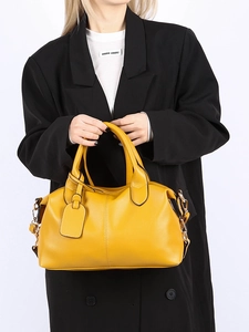 Close-up of ginger yellow litchi pattern leather tote bag with chain strap and matching tag