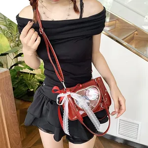 Close-up of red patent leather ita bag featuring a heart window and large lace bow detail
