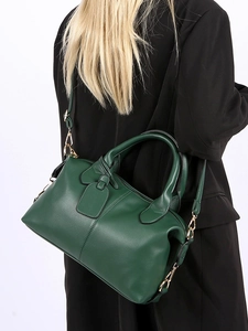 Dark green Boston bag in pebbled leather with gold hardware and adjustable strap