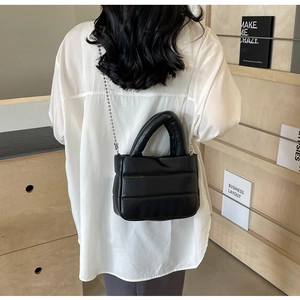 Quilted black PU leather bag with silver bead chain strap shown on model back view