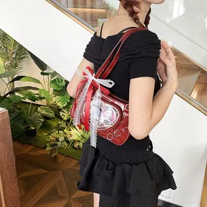 Detail of red patent leather ita bag with lace bow and heart window showing anime cards