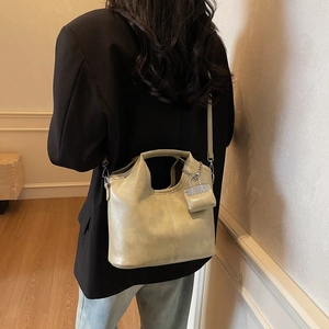Retro faux leather tote bag with chain ornament and mini pouch shown on model