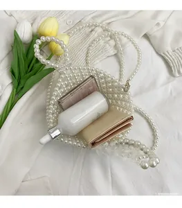 Detail of handmade white pearl woven handbag showing spacious interior for cosmetics