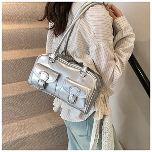 Detail view of a silver Boston bag with front pockets and metallic finish for daily use