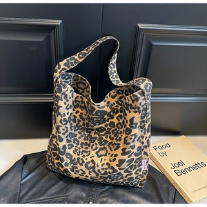 Detail of leopard print canvas tote bag with pink label and hobo style design