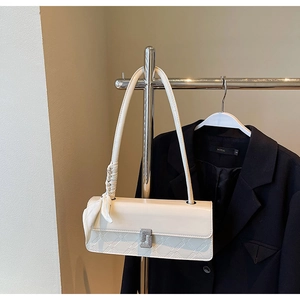 Detail of off-white rectangle shoulder bag with diamond buckle and geometric texture
