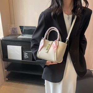 Sac seau minimaliste beige avec poignée foulard en soie et boucle dorée élégante