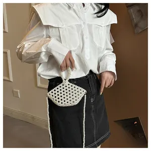Detail view of handmade pearl crossbody bag with beaded strap and fan-shaped design