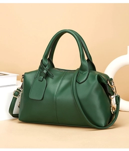 Detailed view of dark green lychee leather tote bag with elegant gold chain strap