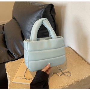 Light blue quilted puffer crossbody bag with top handle and silver bead chain strap