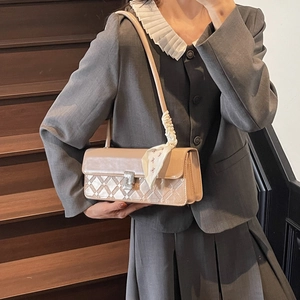 Elegant mauve rectangular shoulder bag with quilted texture and silk scarf decoration