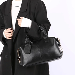 Classic black pebbled leather Boston bag with dual handles and elegant gold hardware