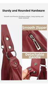 Détail d'un sac en cuir bordeaux montrant l'anneau argenté et le zip métallique