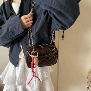 Quilted dark brown patent leather shoulder bag with gold chain and colorful charm