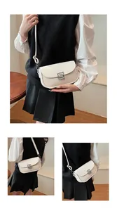 Detail of white leather and beige woven crossbody bag with silver geometric metal buckle