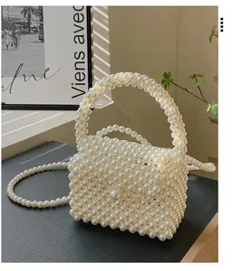 Detail of handmade woven pearl mini bag featuring a sleek top handle and crossbody strap