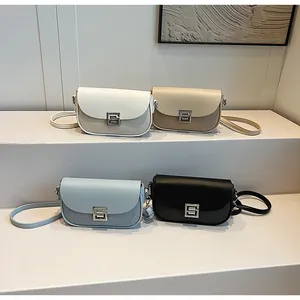 Detail view of four textured crossbody bags in white, beige, light blue, and black colors
