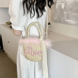 Woven straw bucket bag with pink Moe embroidery, feathers and pearl lace strap