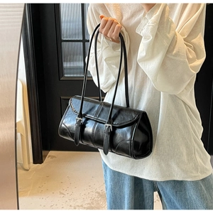 Detail of black retro Boston underarm bag with silver buckles and smooth faux leather