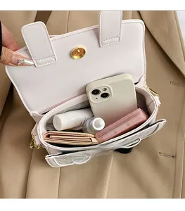 Internal view showing the spacious storage capacity of the pink faux leather saddle bag