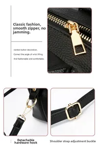 Detail view of smooth zipper, gold hooks, and adjustable strap on black leather bag