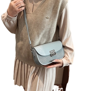 Elegant light blue crossbody saddle bag with mesh texture and silver geometric buckle