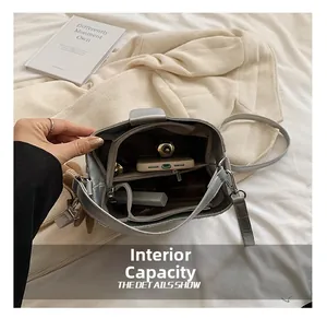 Detailed view of the grey bucket bag interior compartments and daily essentials capacity