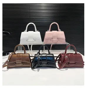 Detail showing various colors of fashion hourglass handbags with curved base design